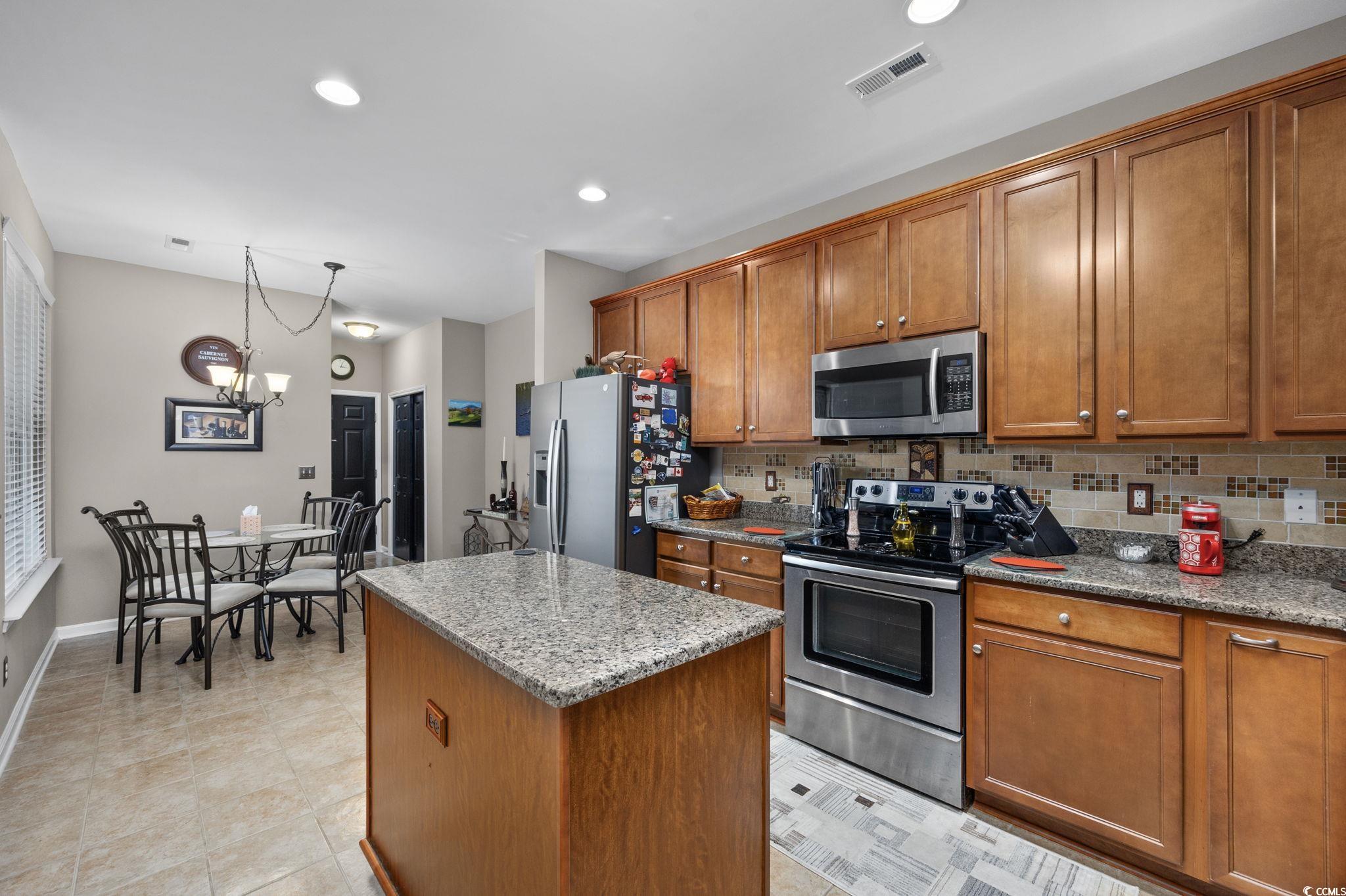 1602 Palmina Loop, Unit 34D Myrtle Beach, SC 29588 - Photo 12 of 28 Kitchen featuring light stone countertops, applian