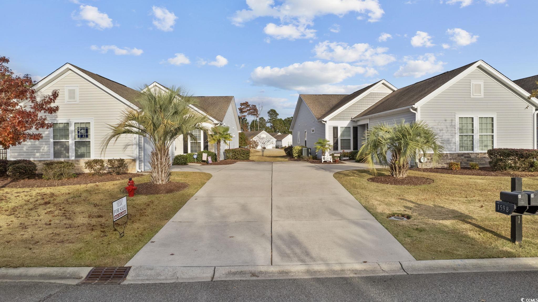 1602 Palmina Loop, Unit 34D Myrtle Beach, SC 29588 - Photo 3 of 28 View of front facade with a front lawn