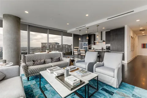 a living room with furniture and a floor to ceiling window