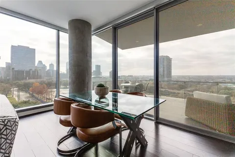 a living room with furniture and floor to ceiling window