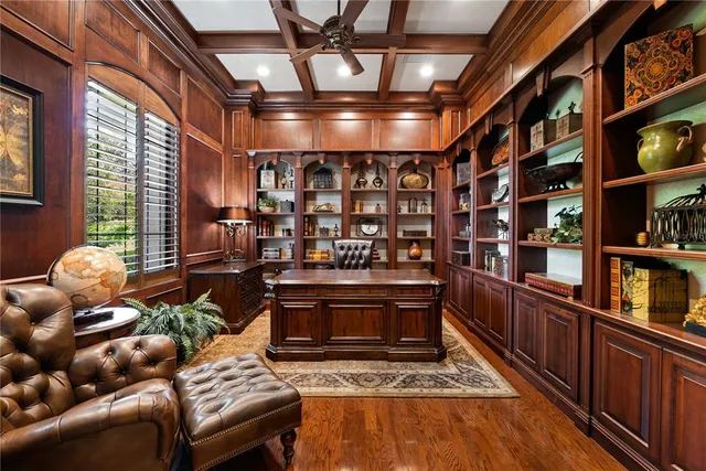 a living room with furniture a fireplace and large windows