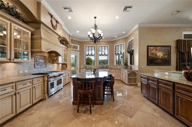 a kitchen with stainless steel appliances granite countertop a stove and a sink
