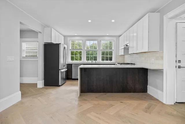 a kitchen with a refrigerator and a sink