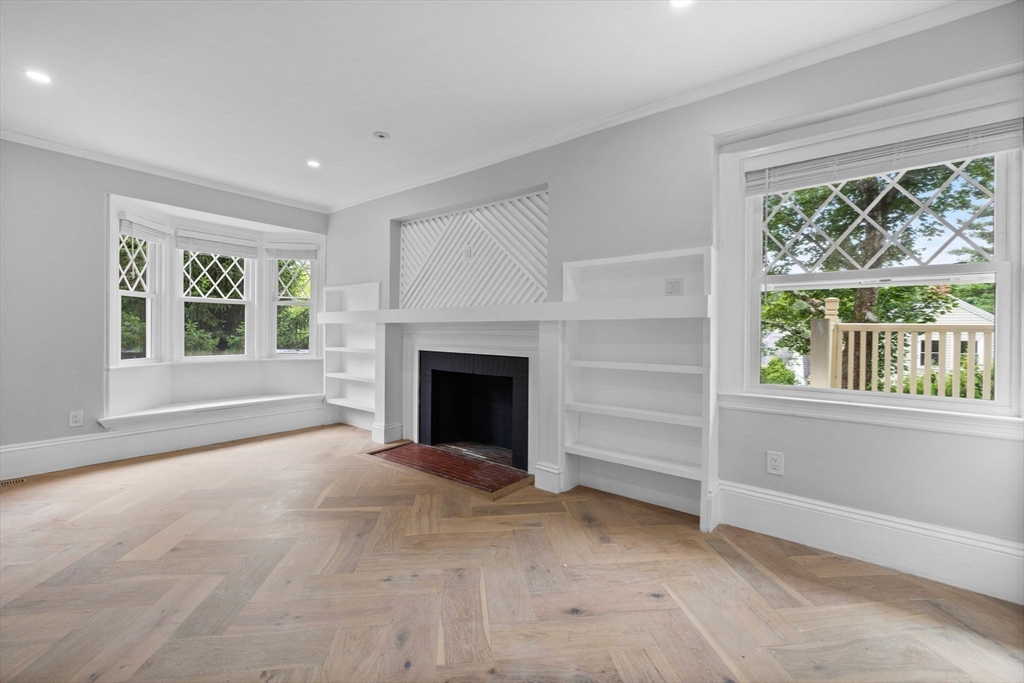 476 A Heath Street Brookline, MA 02467 - Photo 20 of 39 en empty room with windows and fireplace