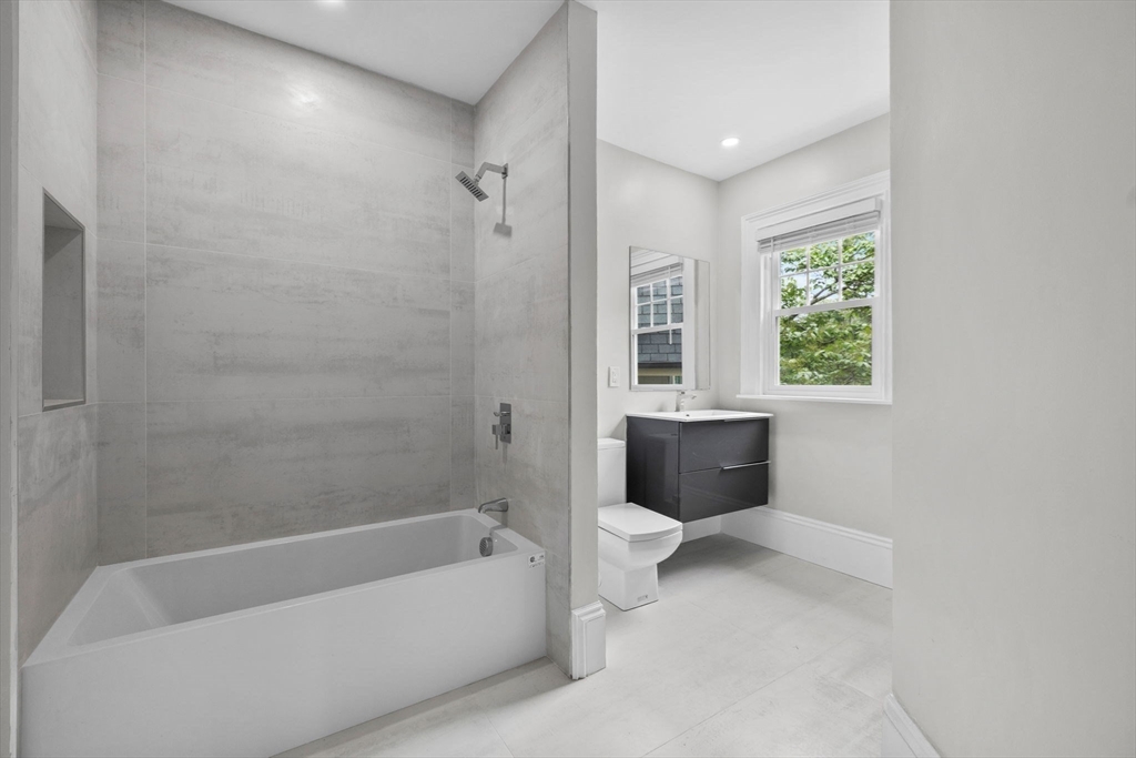 476 A Heath Street Brookline, MA 02467 - Photo 22 of 39 a bathroom with a bathtub toilet sink and window