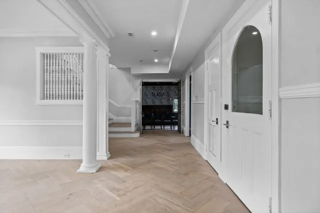 a view of a hallway with wooden shelves and entryway
