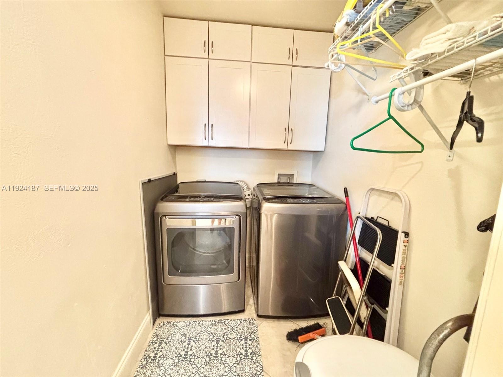 9273 Collins Avenue, Unit 705 Surfside, FL 33154 - Photo 14 of 40 a bathroom with a sink a toilet and a mirror