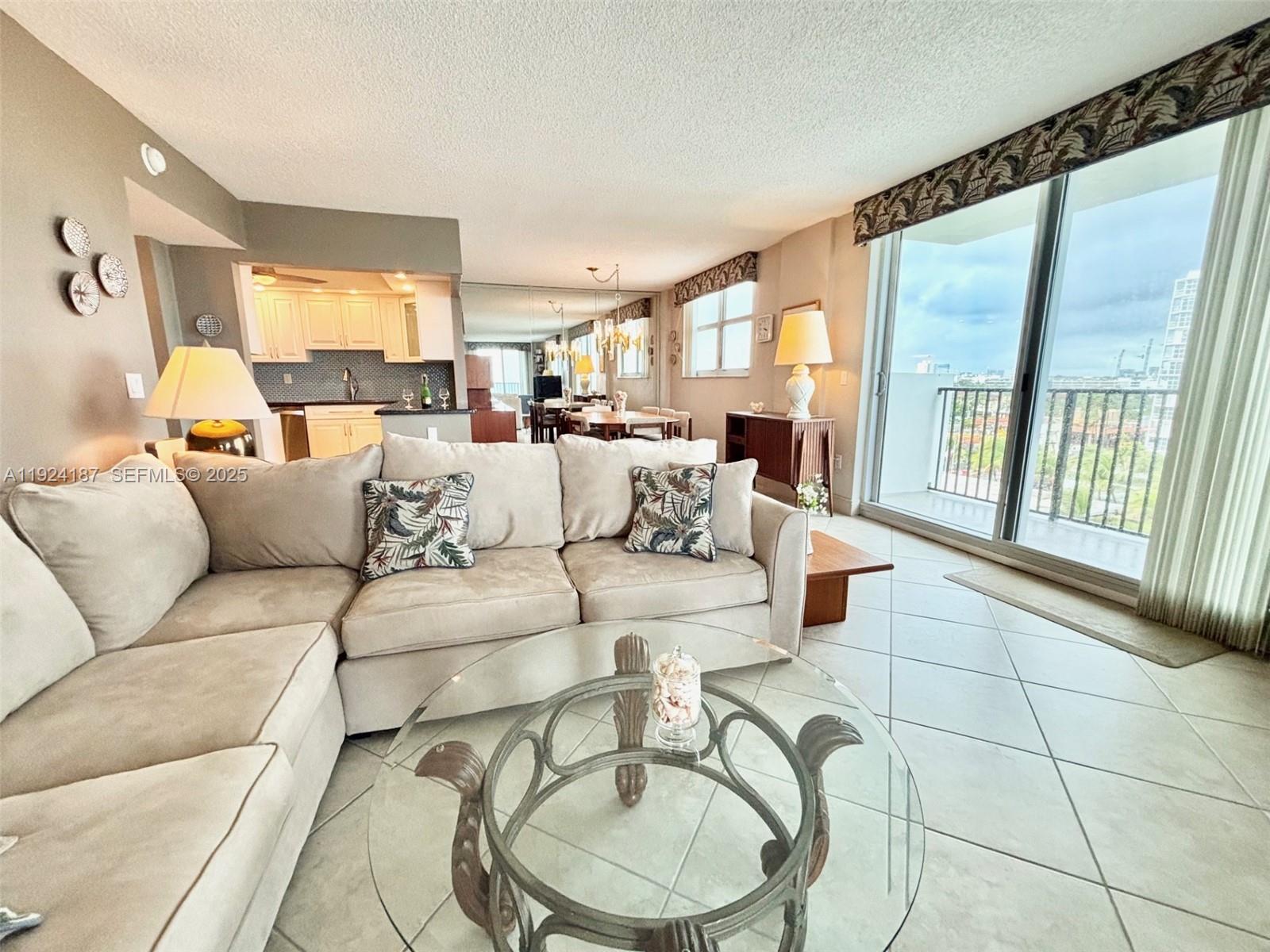 9273 Collins Avenue, Unit 705 Surfside, FL 33154 - Photo 18 of 40 a living room with furniture and a large window