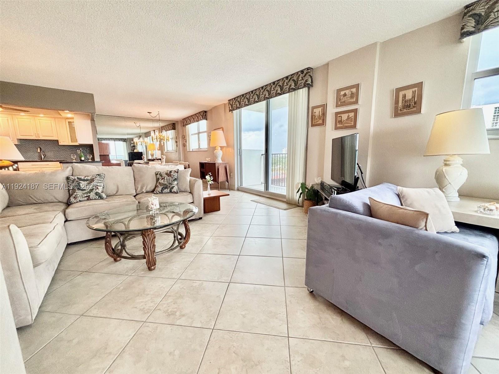 9273 Collins Avenue, Unit 705 Surfside, FL 33154 - Photo 19 of 40 a living room with furniture and a large window