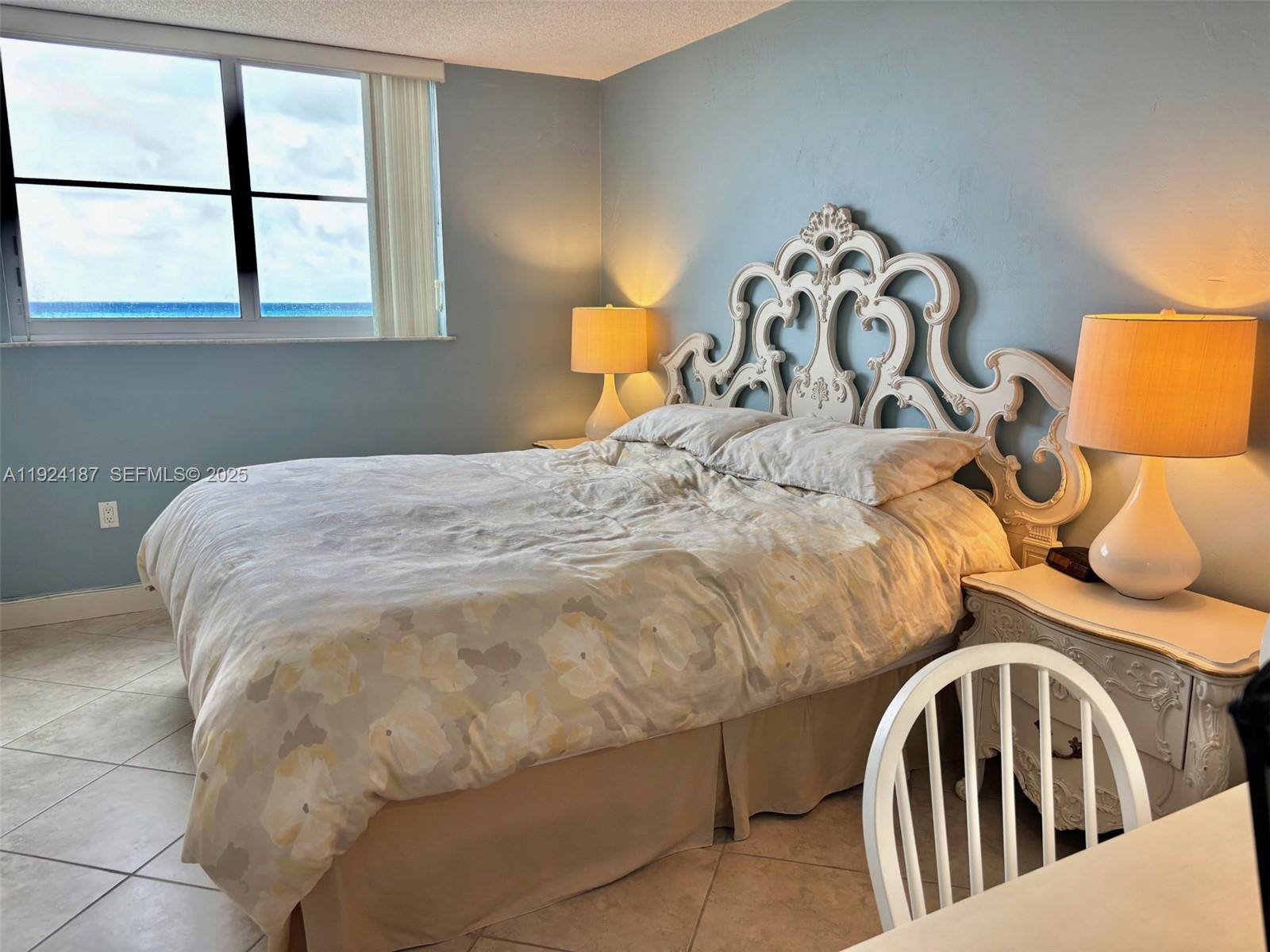 9273 Collins Avenue, Unit 705 Surfside, FL 33154 - Photo 29 of 40 a bedroom with a bed and window