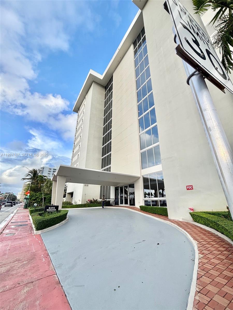 9273 Collins Avenue, Unit 705 Surfside, FL 33154 - Photo 34 of 40 a front view of a house with a yard