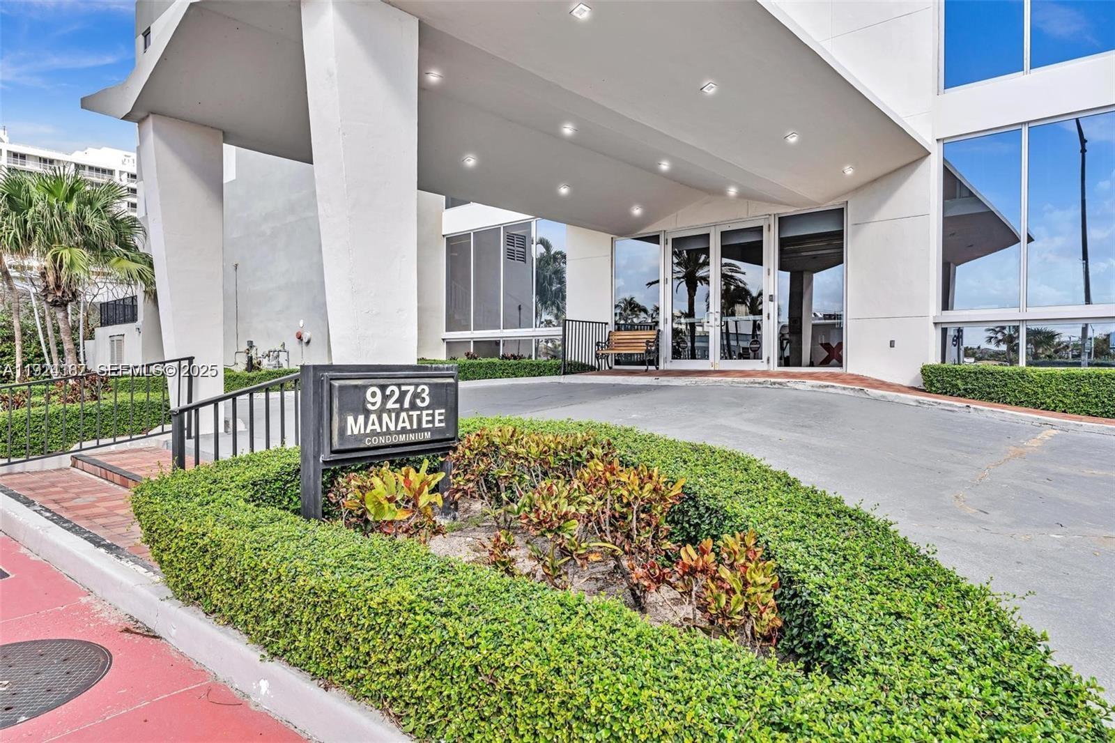 9273 Collins Avenue, Unit 705 Surfside, FL 33154 - Photo 35 of 40 a view of a patio with table and chairs potted plants with wooden floor