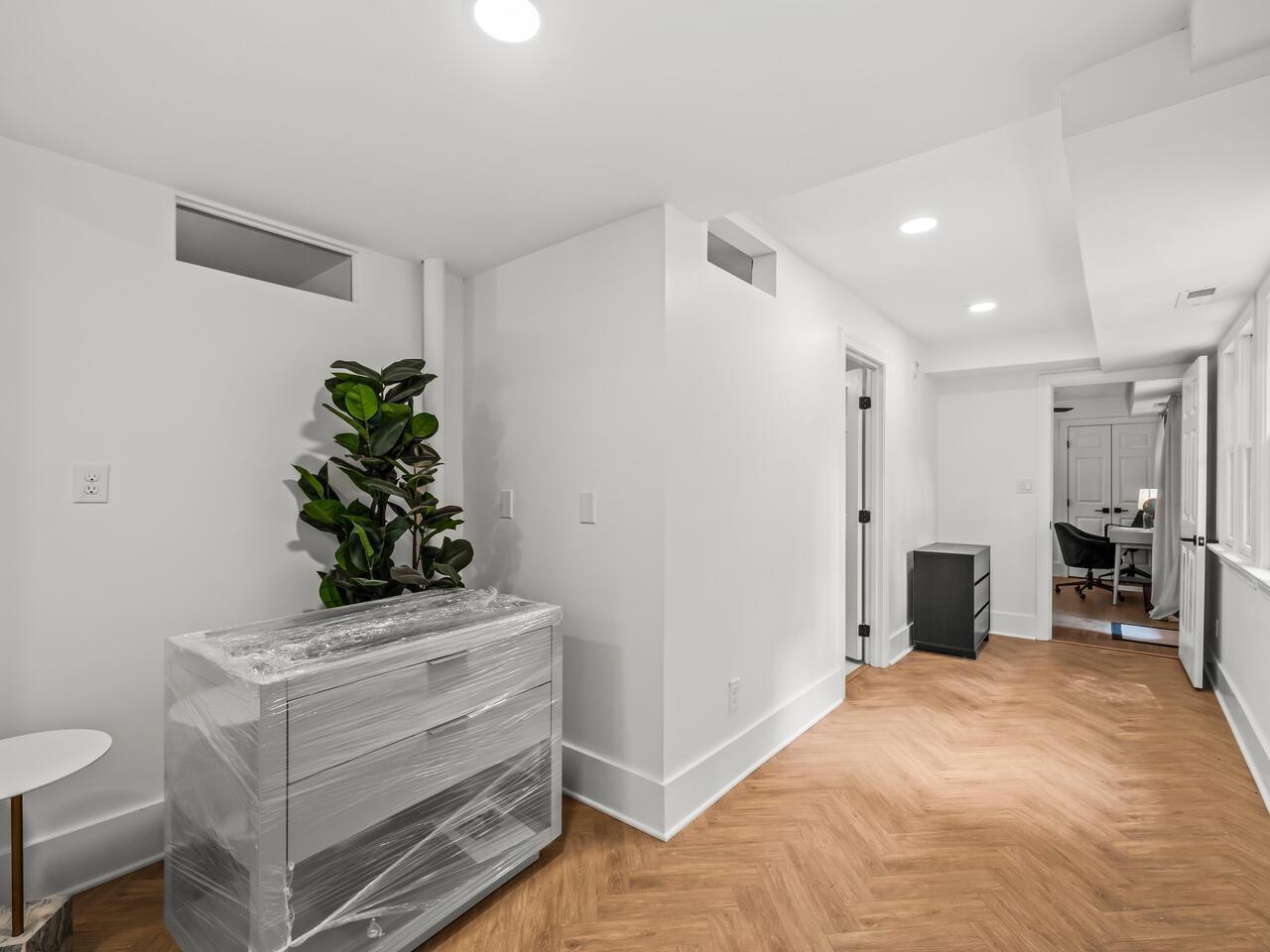 300 Dartmouth Road Raleigh, NC 27609 - Photo 18 of 28 a view of an empty room and kitchen with wooden floor