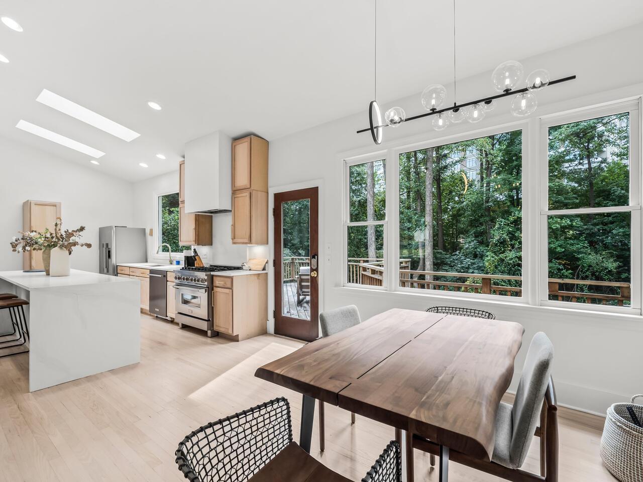 300 Dartmouth Road Raleigh, NC 27609 - Photo 7 of 28 a view of a dining room with furniture large windows and wooden floor