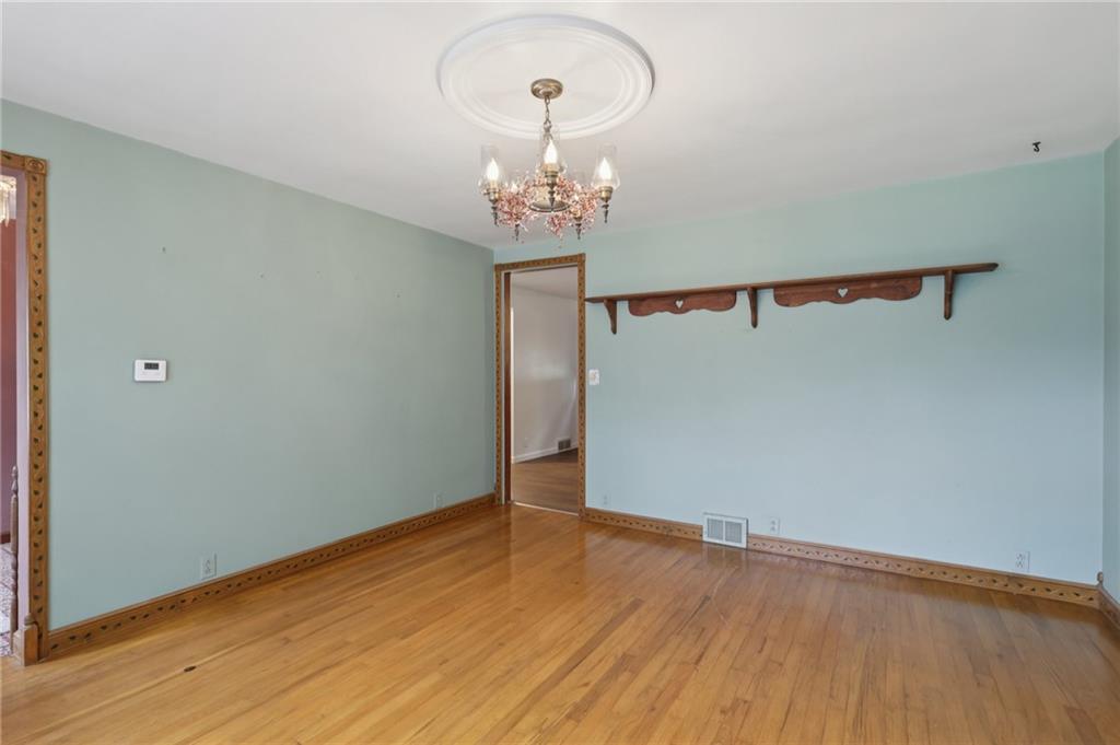 714 Colonial Drive Apollo, PA 15613 - Photo 14 of 32 a view of a hallway with wooden floor and a chandelier