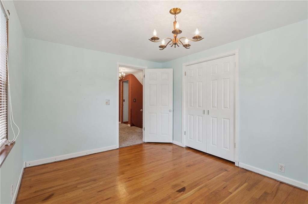 714 Colonial Drive Apollo, PA 15613 - Photo 24 of 32 a view of an empty room with wooden floor and chandelier