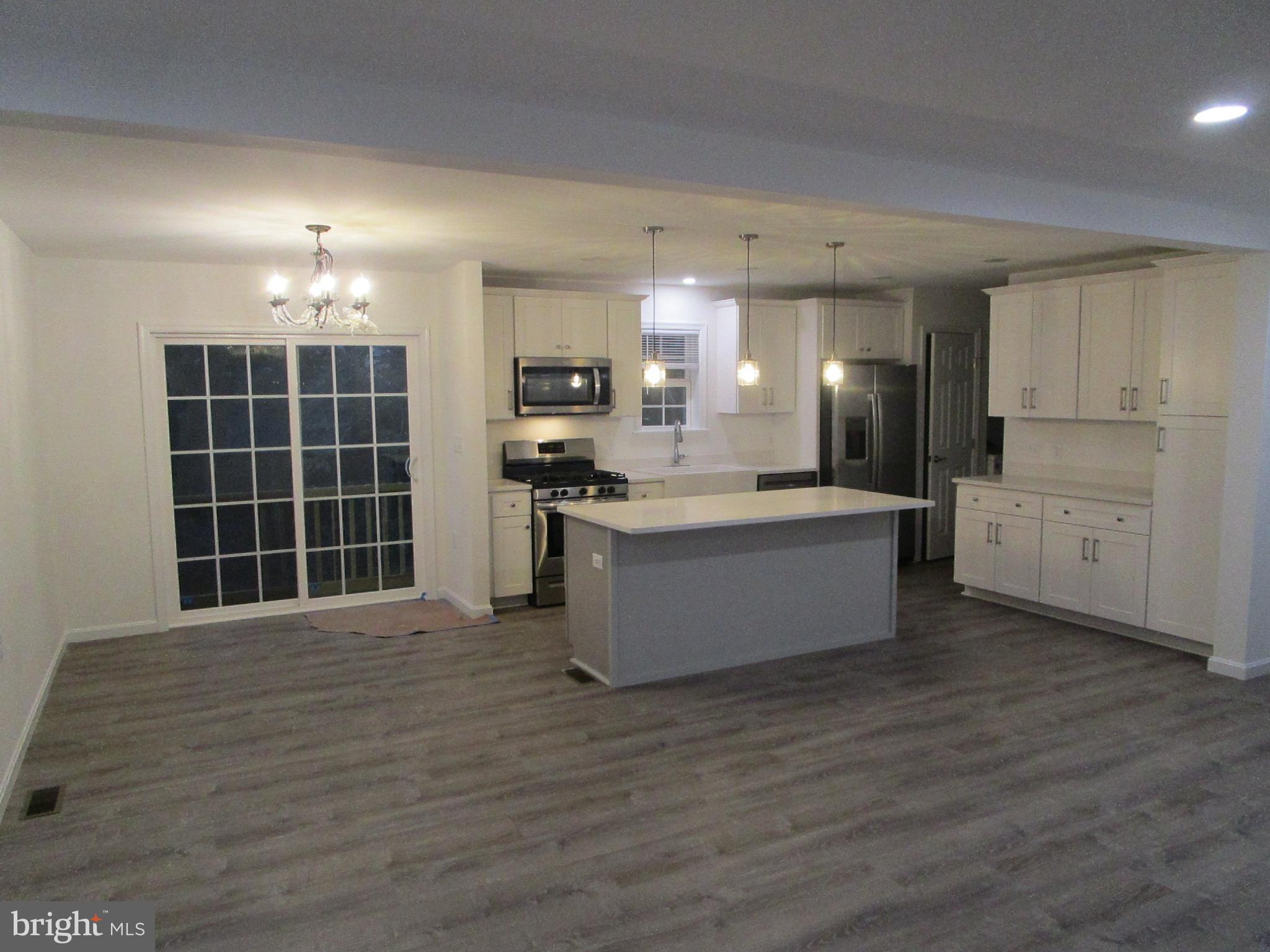 32 Tiffany Drive Rehoboth Beach, DE 19971 - Photo 43 of 43 a large kitchen with kitchen island a sink stainless steel appliances and cabinets