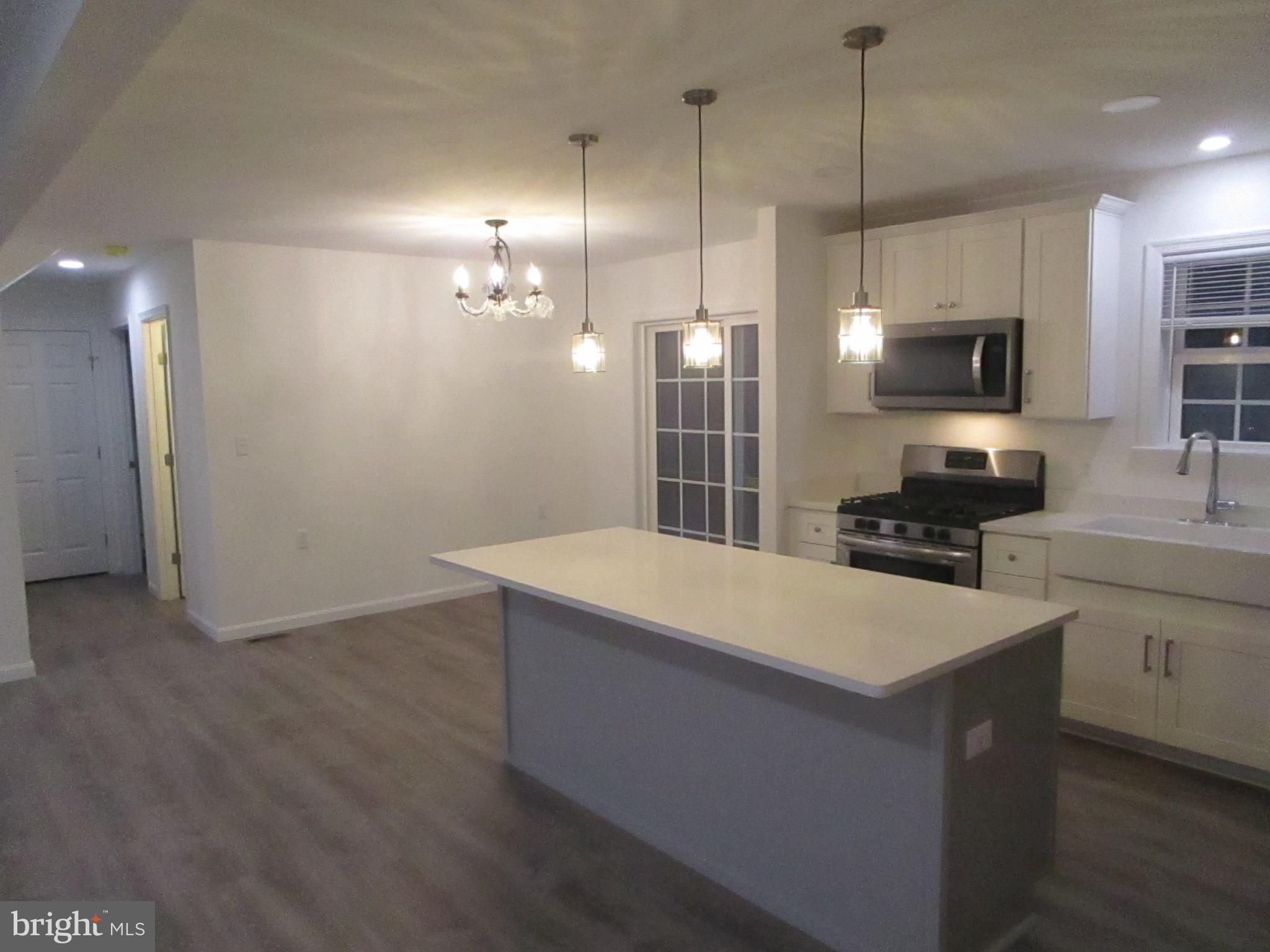 32 Tiffany Drive Rehoboth Beach, DE 19971 - Photo 11 of 43 a large kitchen with kitchen island a sink stainless steel appliances and cabinets