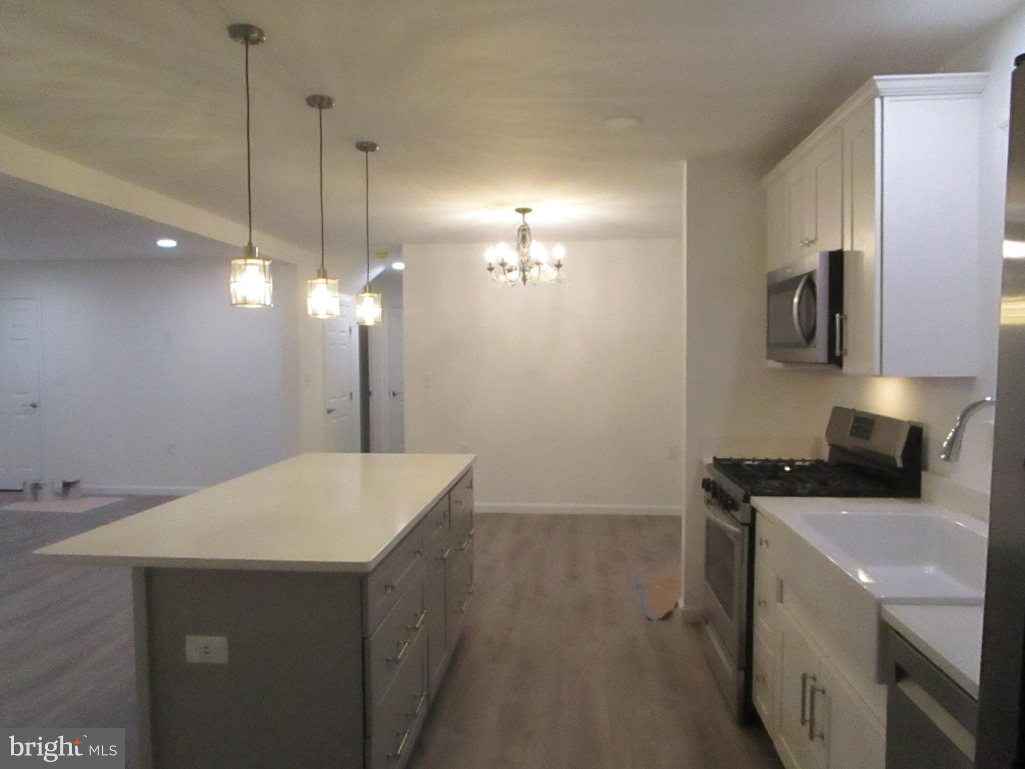 32 Tiffany Drive Rehoboth Beach, DE 19971 - Photo 12 of 43 a kitchen that has a sink stainless steel appliances a counter space and a sink