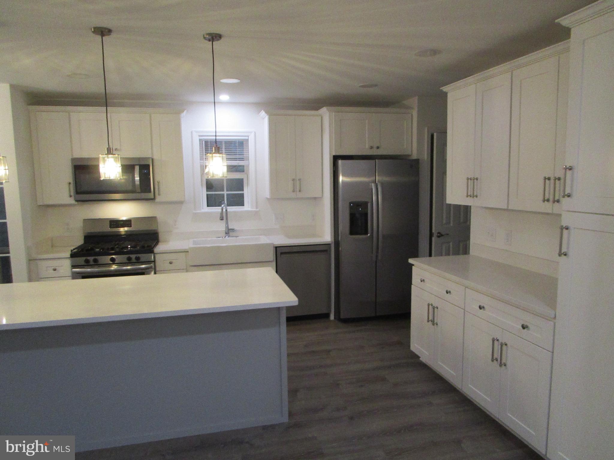 32 Tiffany Drive Rehoboth Beach, DE 19971 - Photo 14 of 43 a kitchen with stainless steel appliances a refrigerator sink and stove
