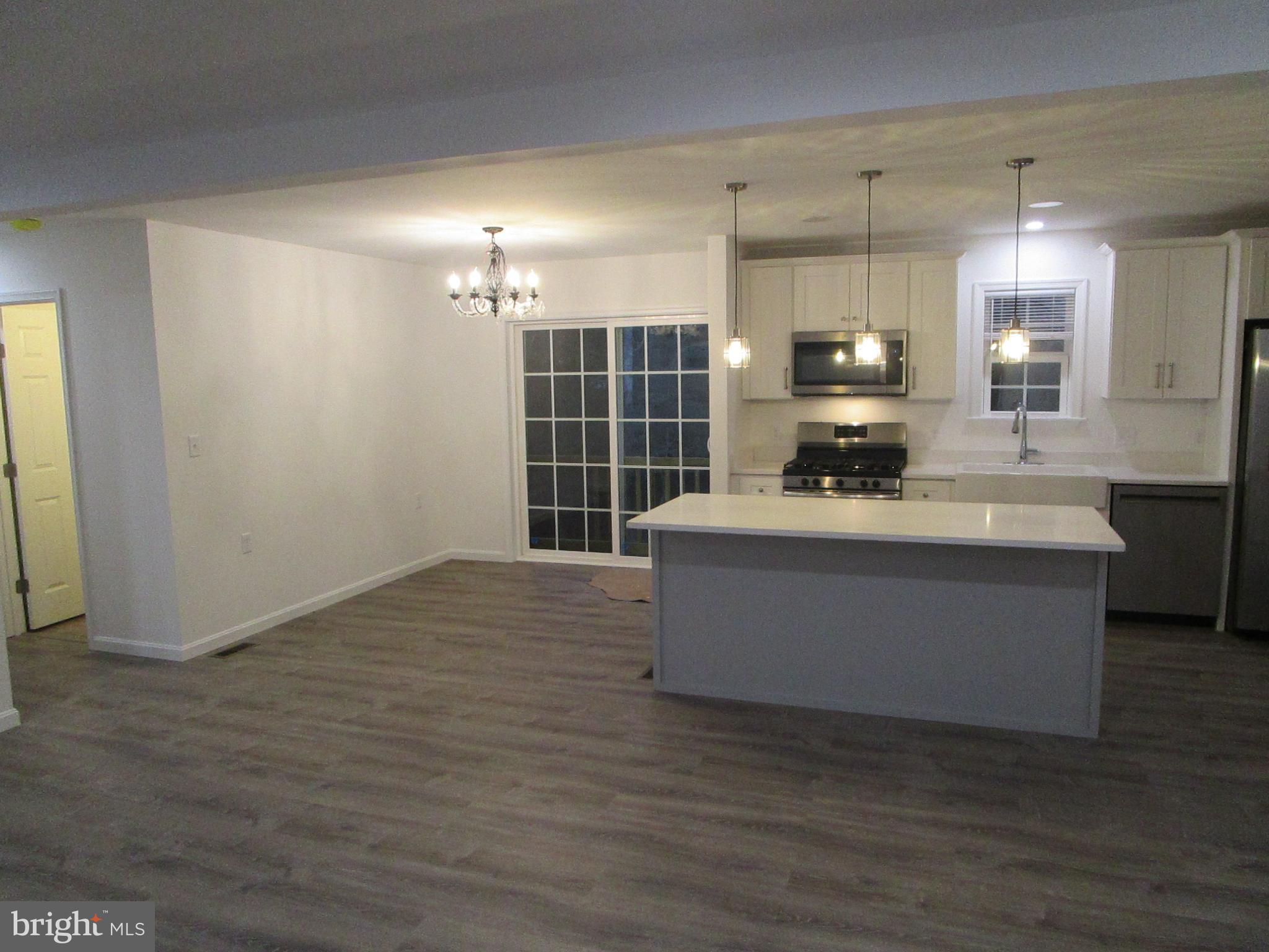 32 Tiffany Drive Rehoboth Beach, DE 19971 - Photo 15 of 43 a large kitchen with kitchen island a sink stainless steel appliances and cabinets