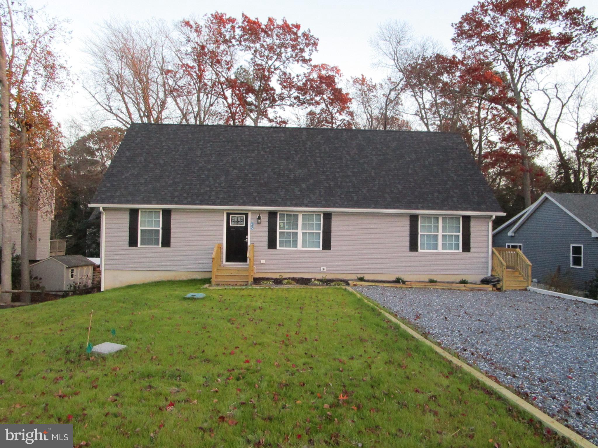 32 Tiffany Drive Rehoboth Beach, DE 19971 - Photo 2 of 43 front view of a house with a yard