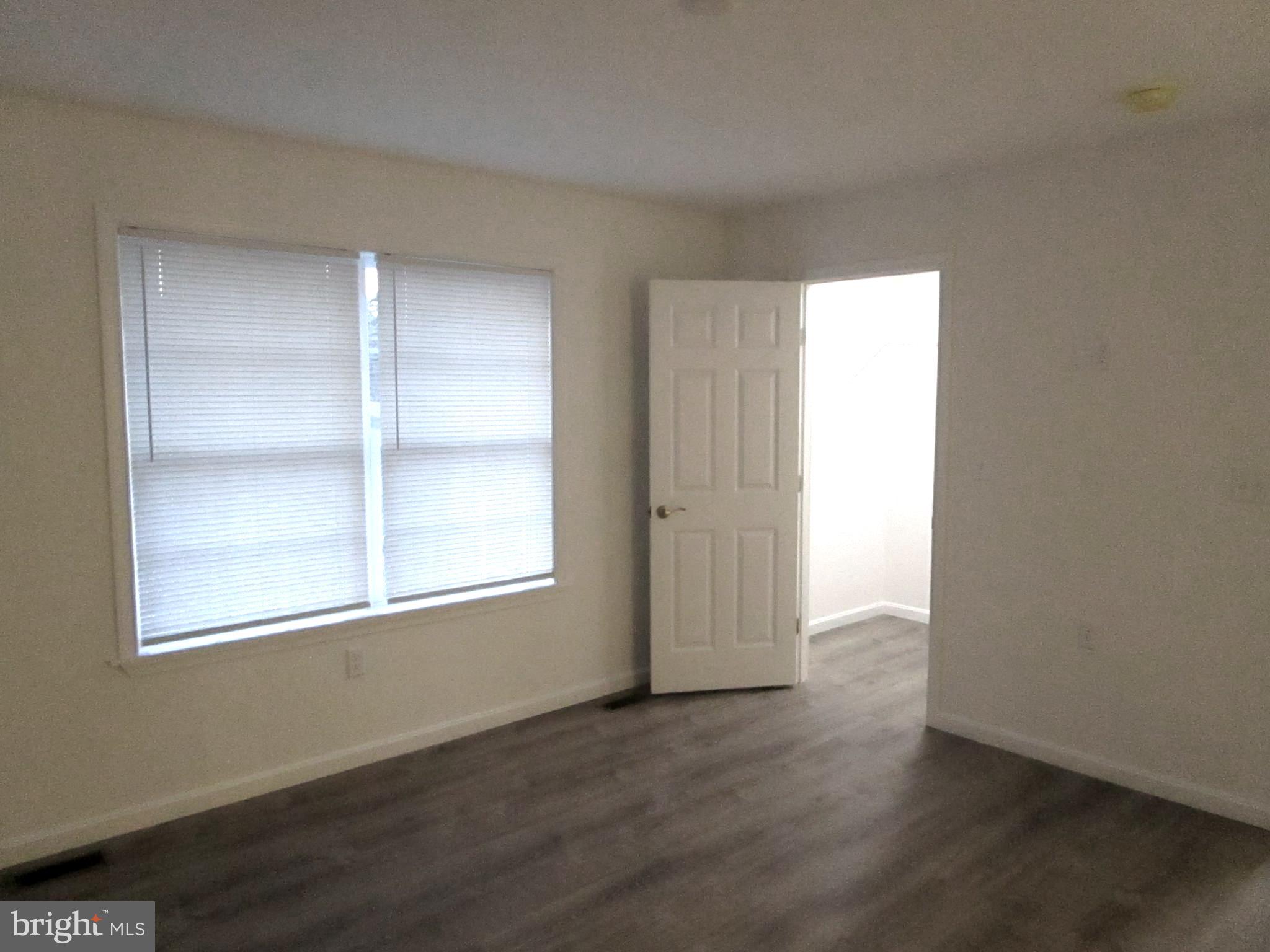 32 Tiffany Drive Rehoboth Beach, DE 19971 - Photo 23 of 43 an empty room with wooden floor and windows
