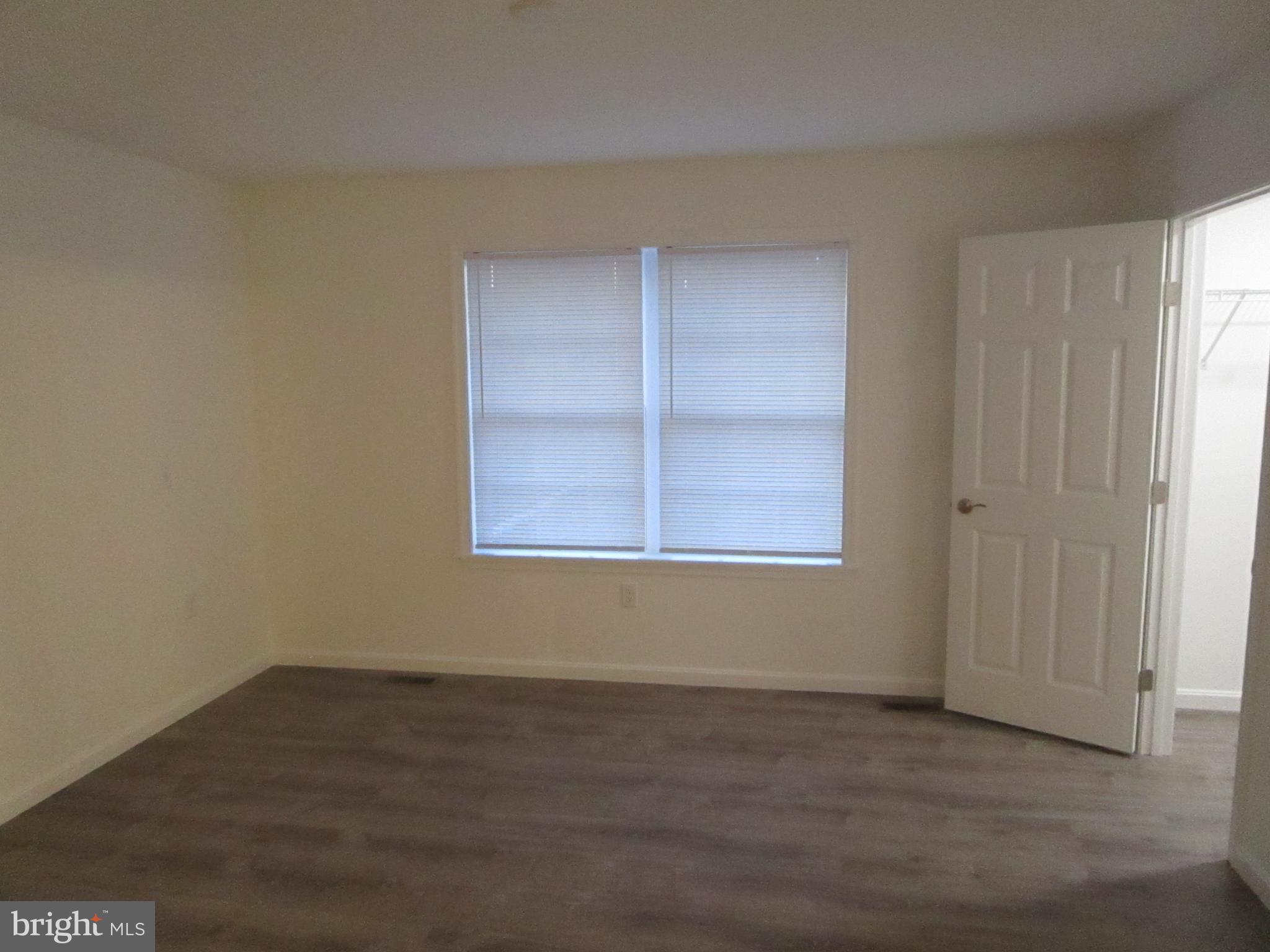 32 Tiffany Drive Rehoboth Beach, DE 19971 - Photo 24 of 43 an empty room with wooden floor and windows