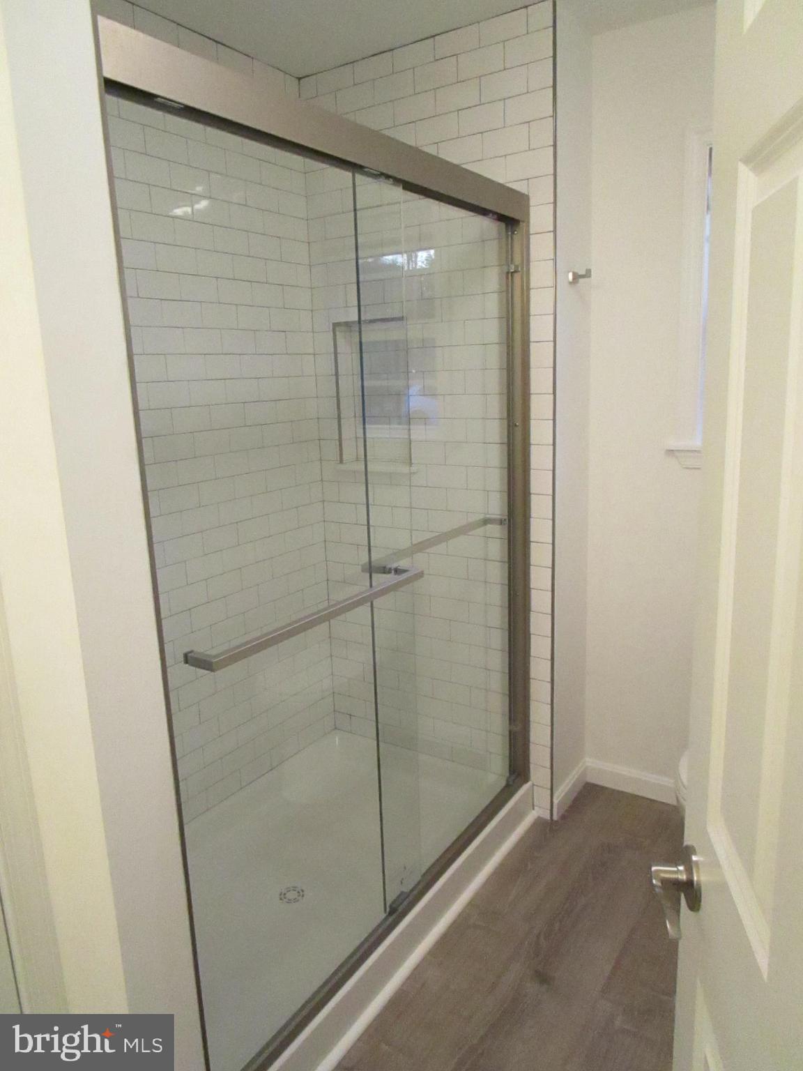 32 Tiffany Drive Rehoboth Beach, DE 19971 - Photo 26 of 43 a bathroom with a glass shower door