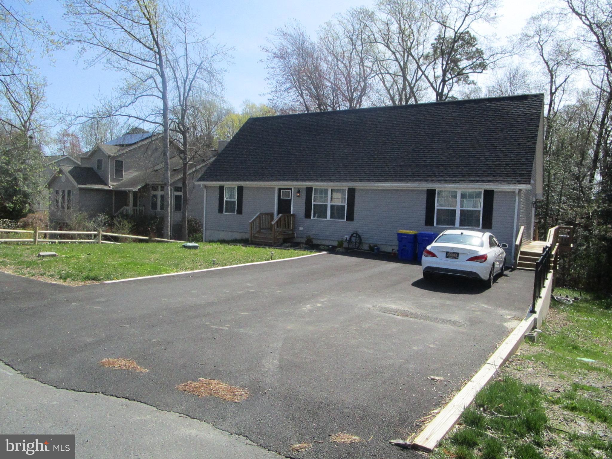 32 Tiffany Drive Rehoboth Beach, DE 19971 - Photo 42 of 43 a car parked in front of white house