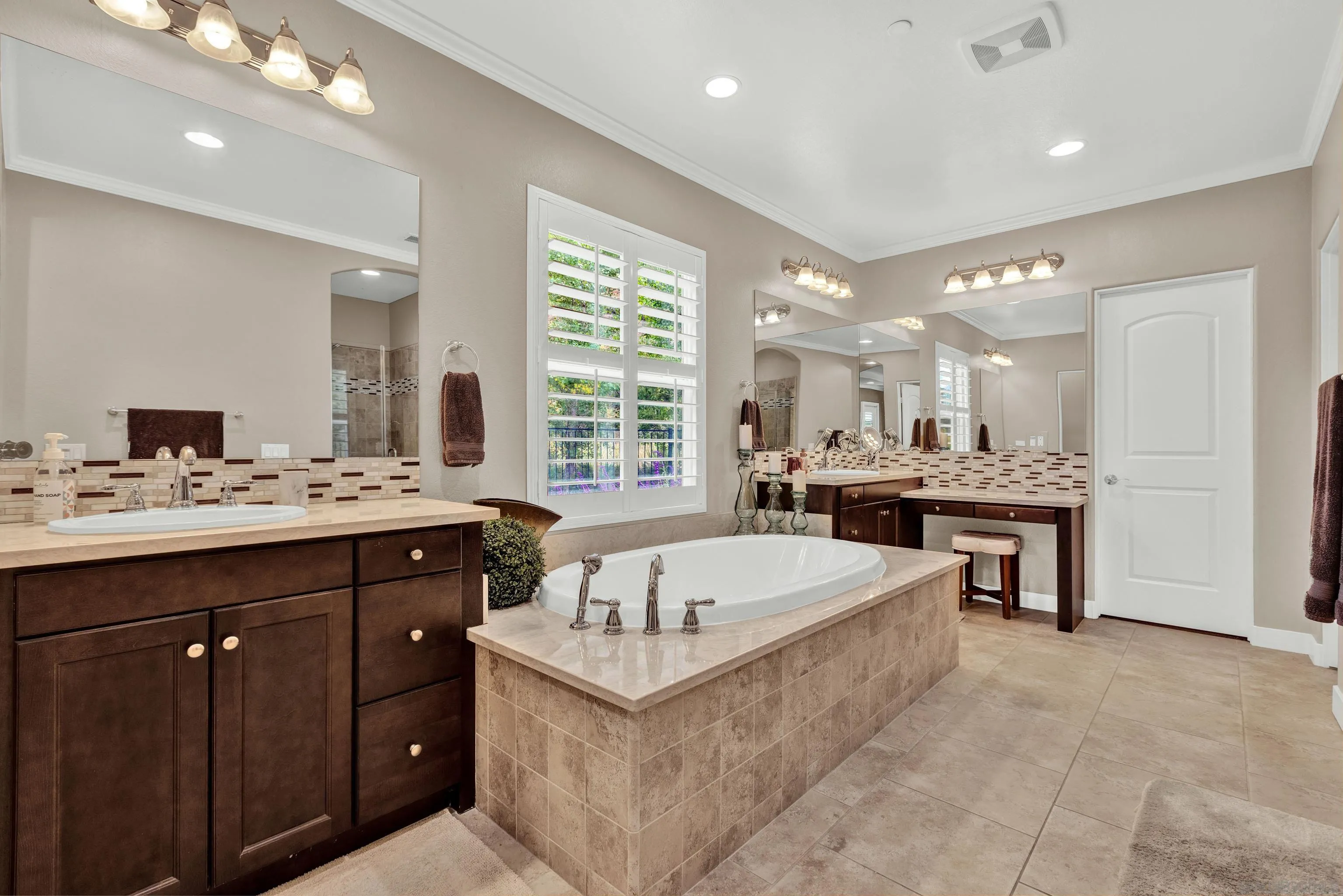 12884 Vineyard Crest Place Lakeside, CA 92040 - Photo 11 of 53 a large white kitchen with a large island oven a sink stainless steel appliances and window