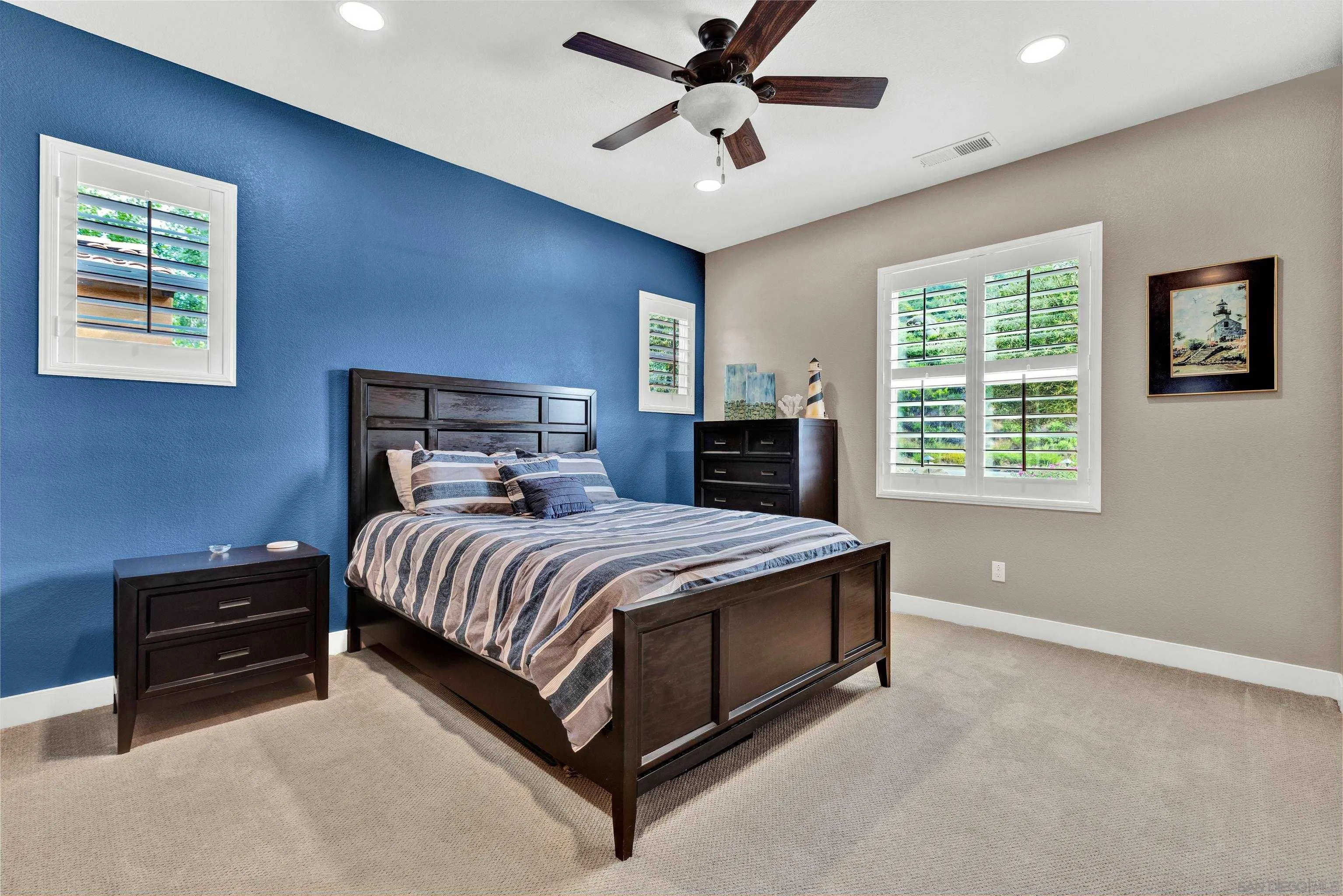 12884 Vineyard Crest Place Lakeside, CA 92040 - Photo 24 of 53 a bedroom with a bed and a ceiling fan