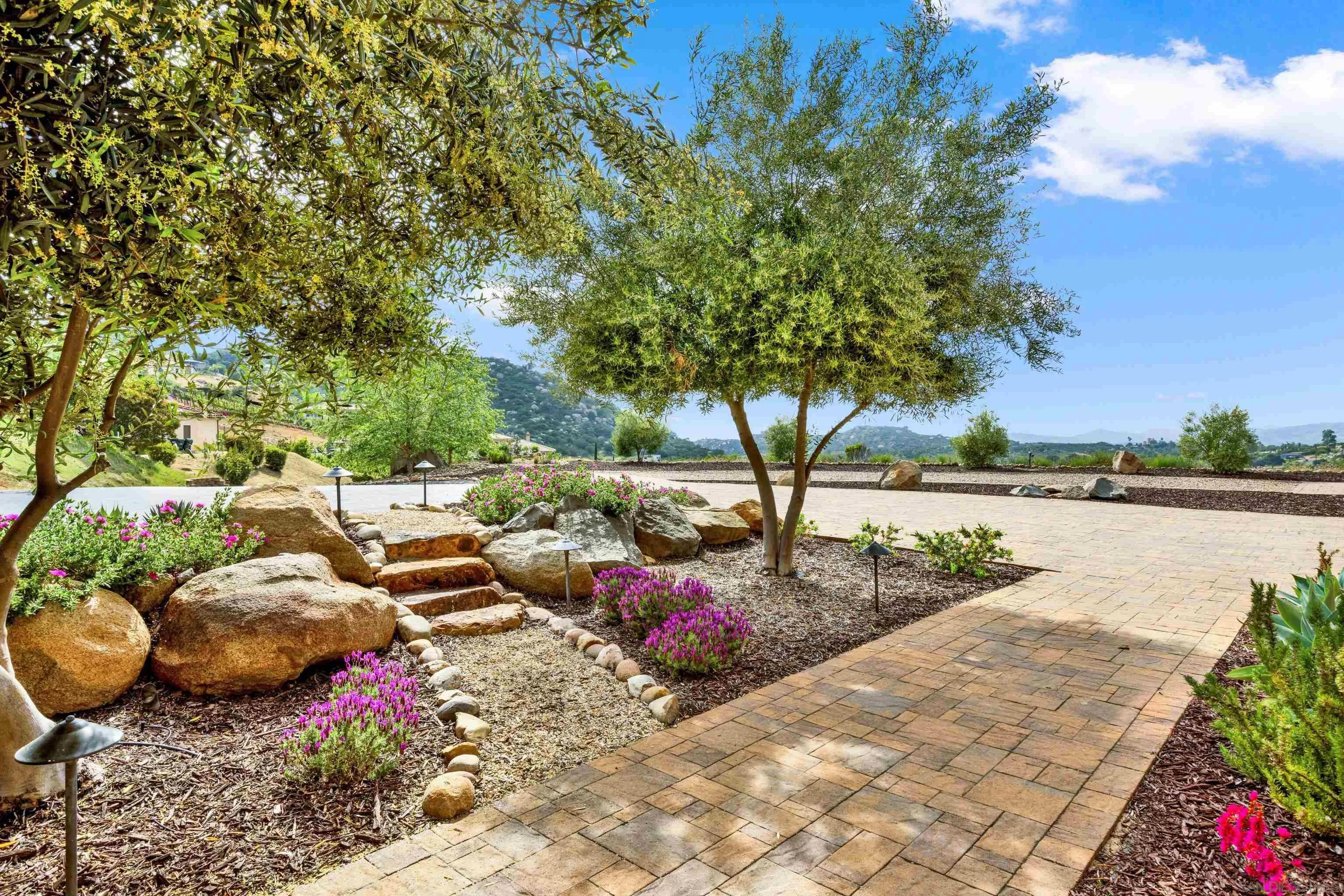 12884 Vineyard Crest Place Lakeside, CA 92040 - Photo 3 of 53 a view of a table and chairs in a patio near a lake