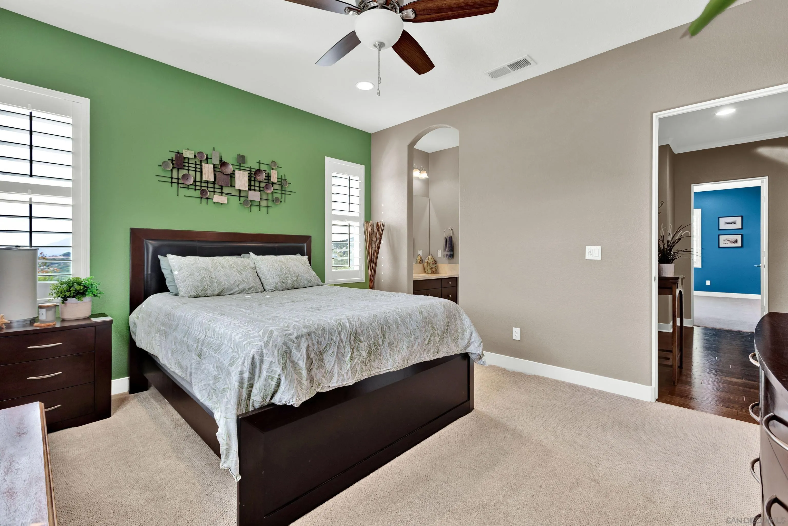 12884 Vineyard Crest Place Lakeside, CA 92040 - Photo 34 of 53 a spacious bedroom with a bed and a chandelier