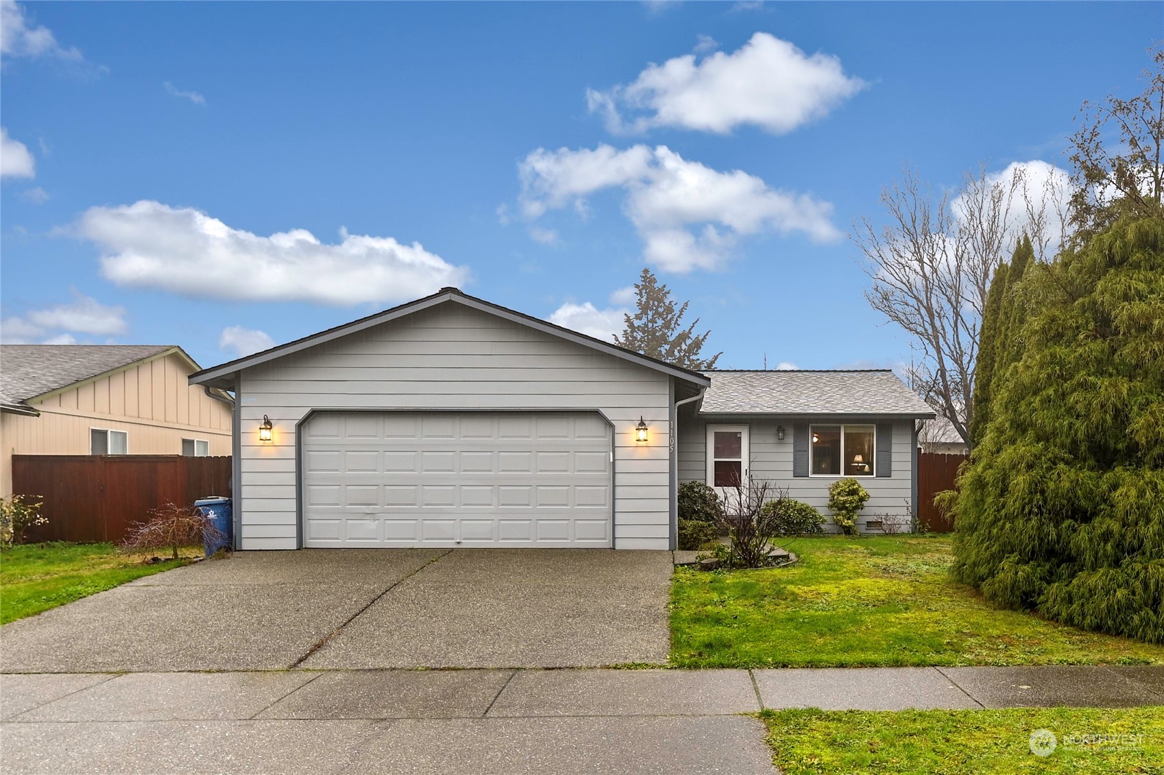 a front view of a house with a yard and garage