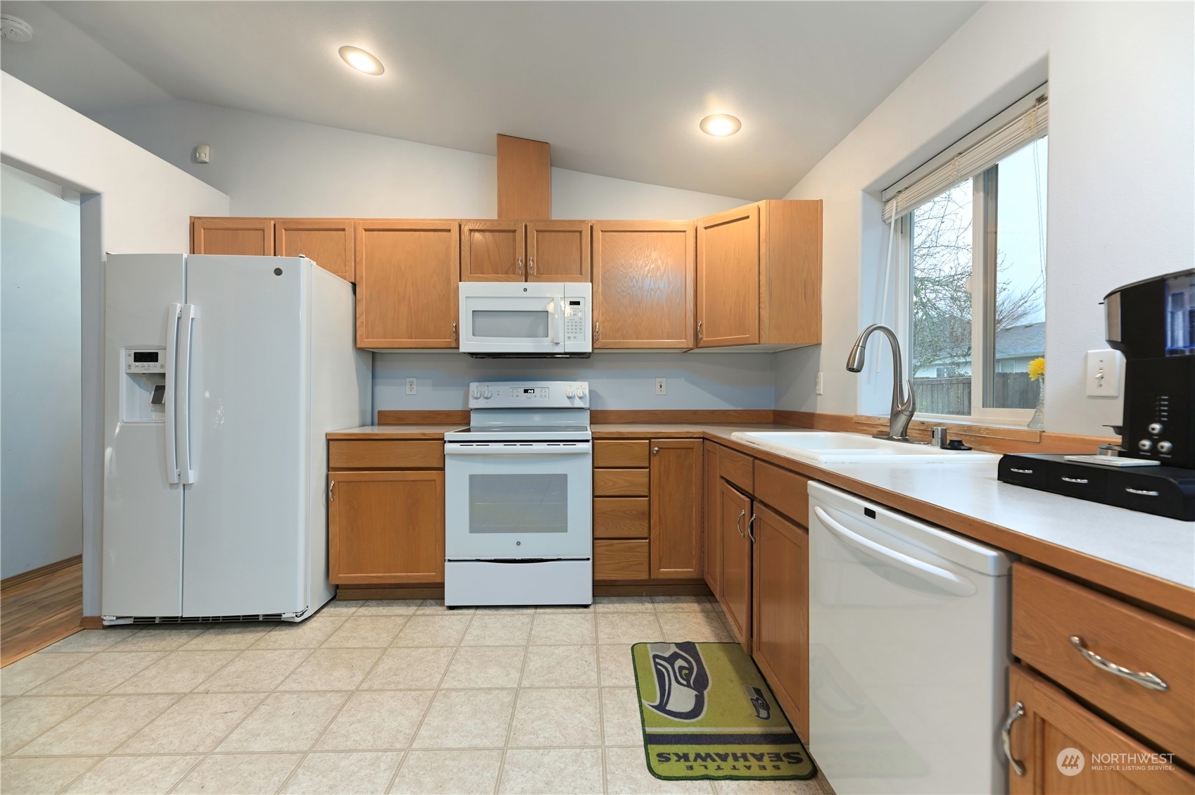 1105 Kessler Drive Sultan, WA 98294 - Photo 8 of 25 a kitchen with a refrigerator and a sink
