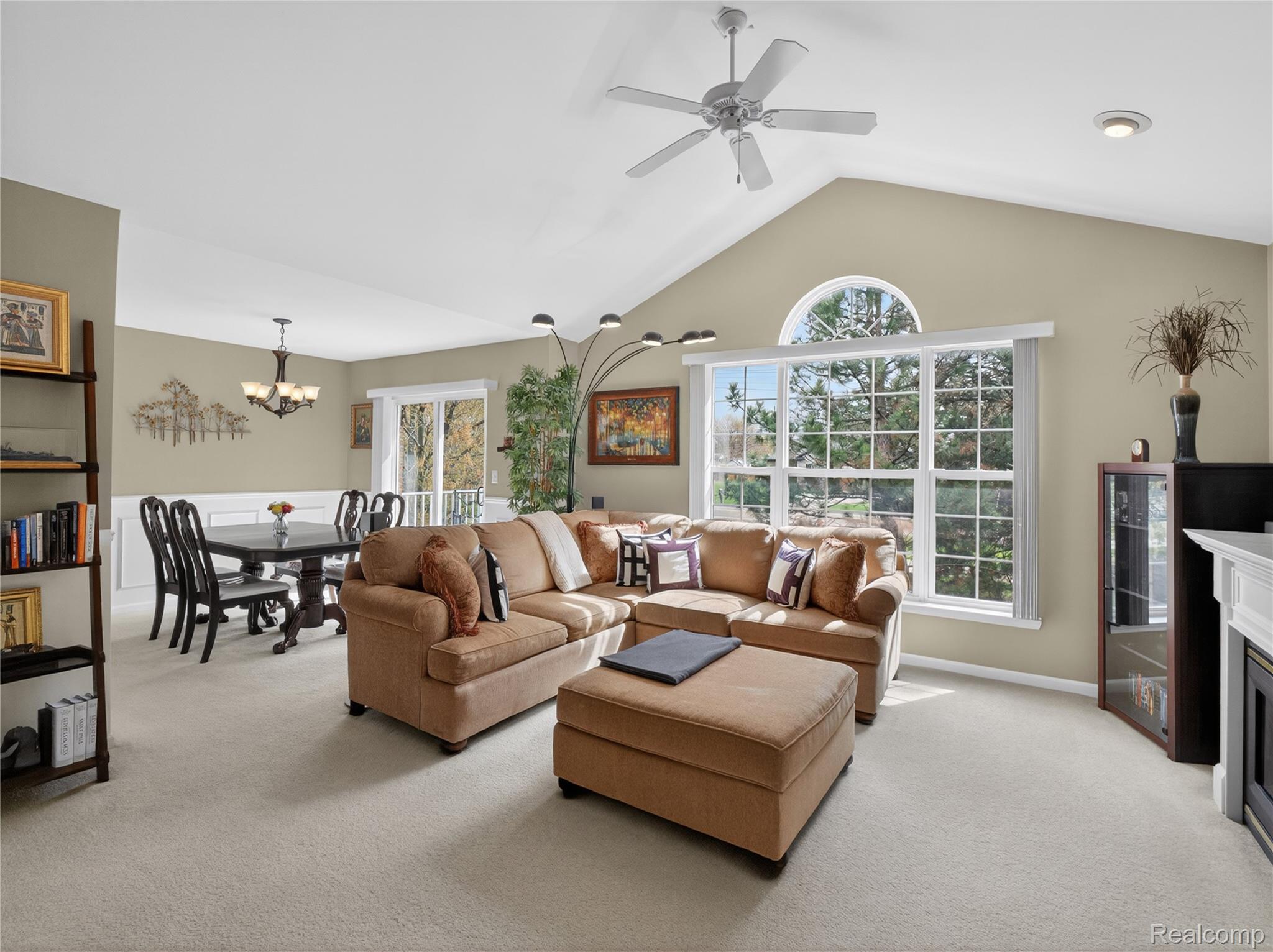 1834 Flagstone Circle, Unit 37 Rochester, MI 48307 - Photo 6 of 31 Living area with light carpet, a fireplace, healthy amount of natural light, and ceiling fan