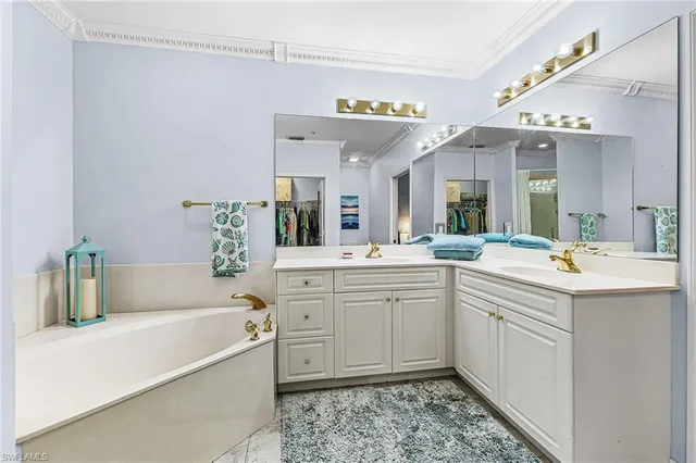 a spacious bathroom with a tub sink and mirror