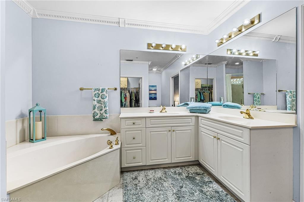 451 Bayfront Place, Unit 5503 Naples, FL 34102 - Photo 11 of 22 a spacious bathroom with a tub sink and mirror