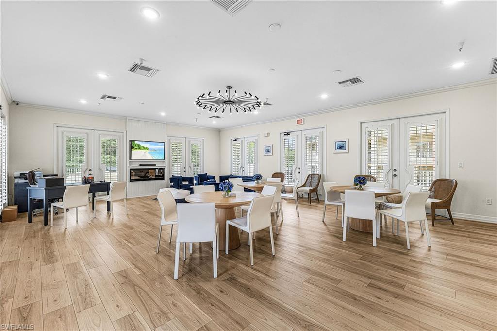 451 Bayfront Place, Unit 5503 Naples, FL 34102 - Photo 14 of 22 a view of a dining room with furniture window and wooden floor