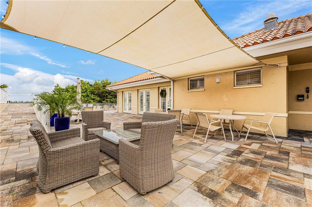 451 Bayfront Place, Unit 5503 Naples, FL 34102 - Photo 15 of 22 a view of a patio with couches and potted plants
