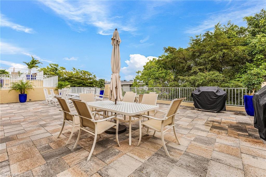 451 Bayfront Place, Unit 5503 Naples, FL 34102 - Photo 16 of 22 a view of an chairs and tables in the patio