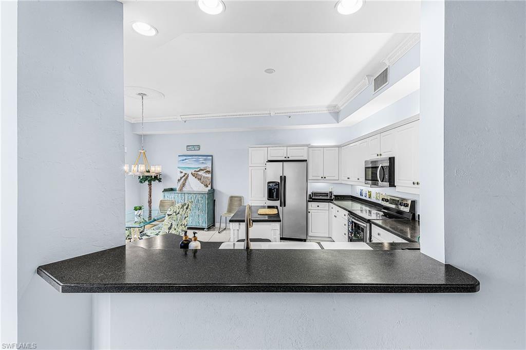 451 Bayfront Place, Unit 5503 Naples, FL 34102 - Photo 20 of 22 a kitchen with kitchen island a counter top a stove and a sink