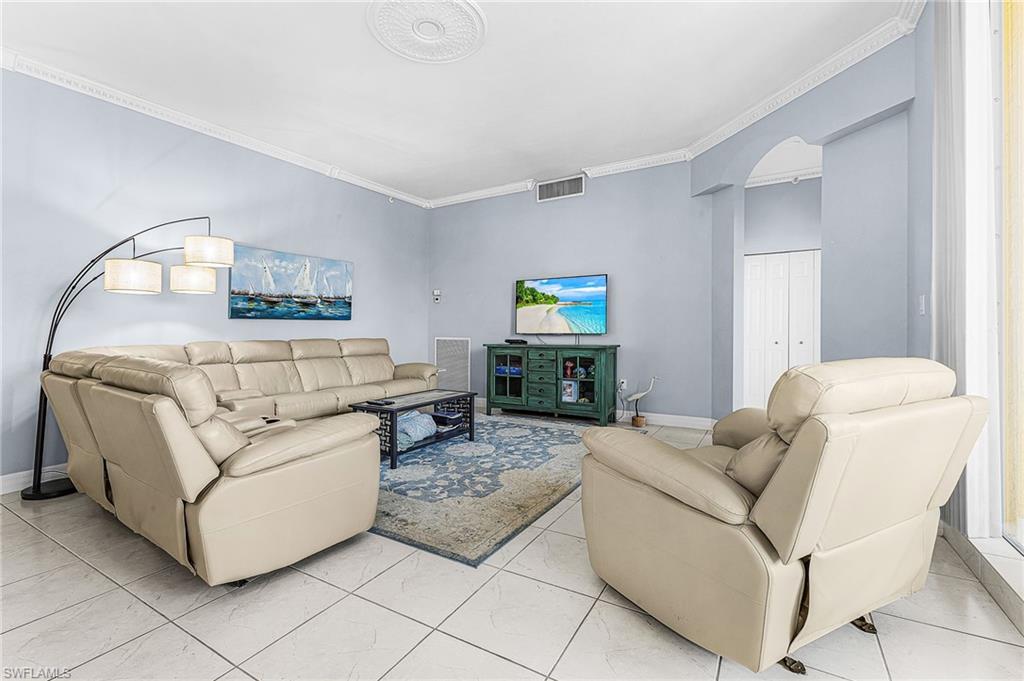 451 Bayfront Place, Unit 5503 Naples, FL 34102 - Photo 2 of 22 a living room with furniture and a flat screen tv