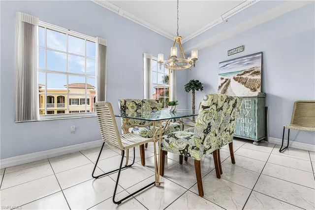 a view of a dining room with furniture and chandelier