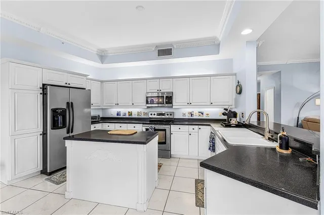 a kitchen with a sink a stove top oven and refrigerator