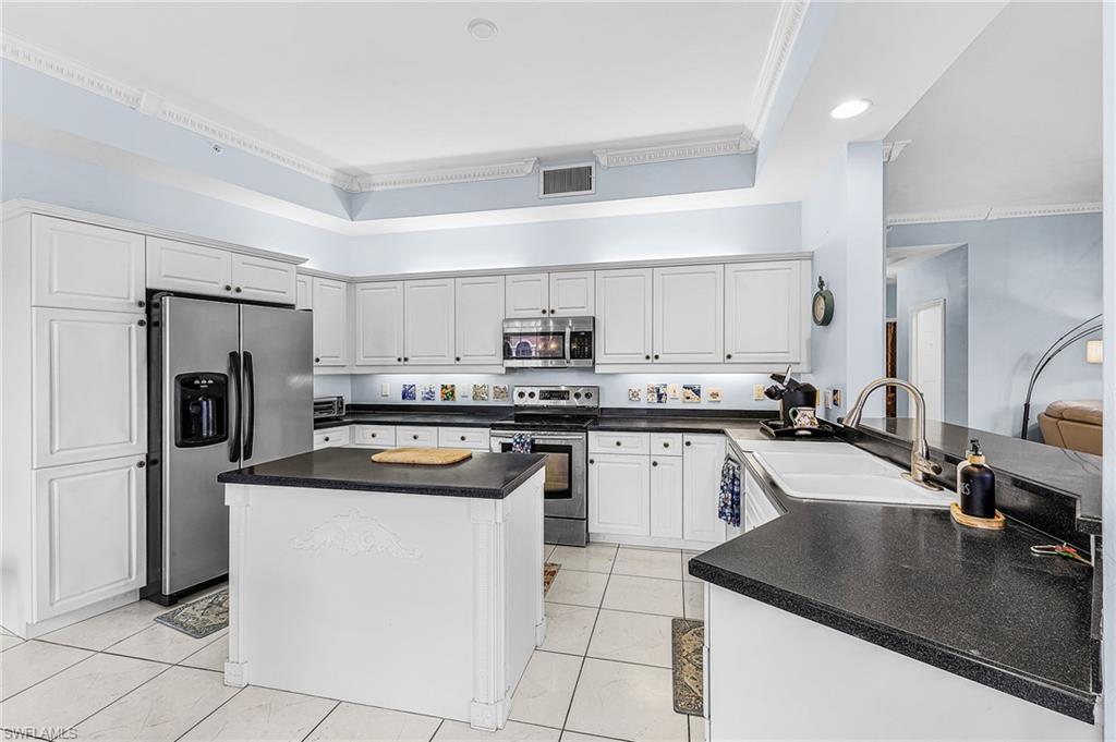 451 Bayfront Place, Unit 5503 Naples, FL 34102 - Photo 5 of 22 a kitchen with a sink a stove top oven and refrigerator