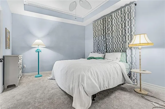 a bed sitting in a bedroom next to a lamp and a lamp