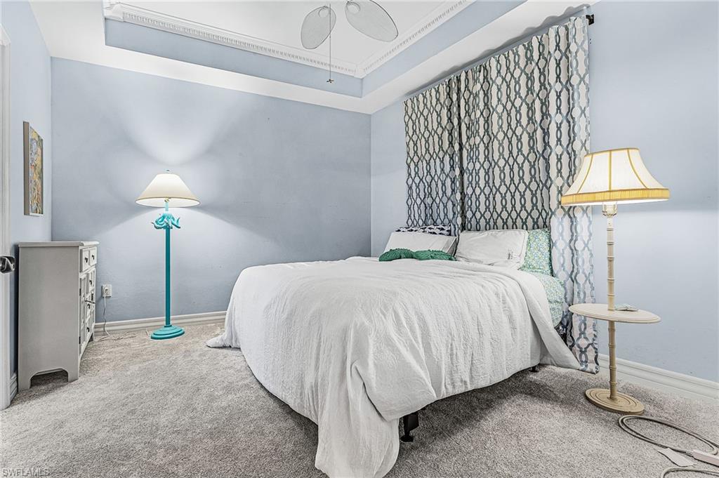 451 Bayfront Place, Unit 5503 Naples, FL 34102 - Photo 8 of 22 a bed sitting in a bedroom next to a lamp and a lamp
