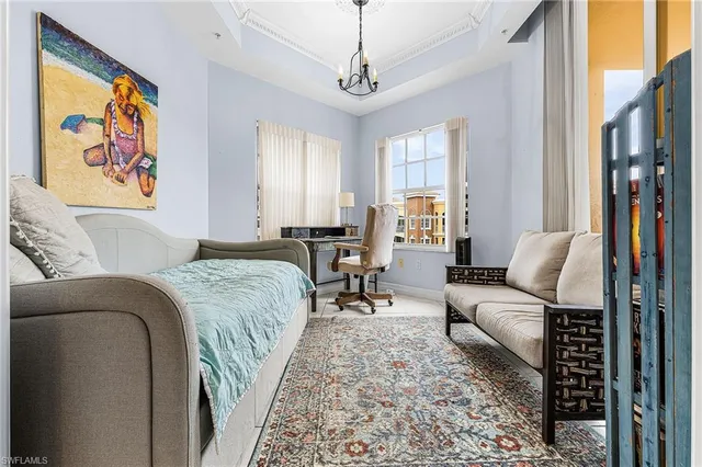 a bedroom with a bed couch and a window